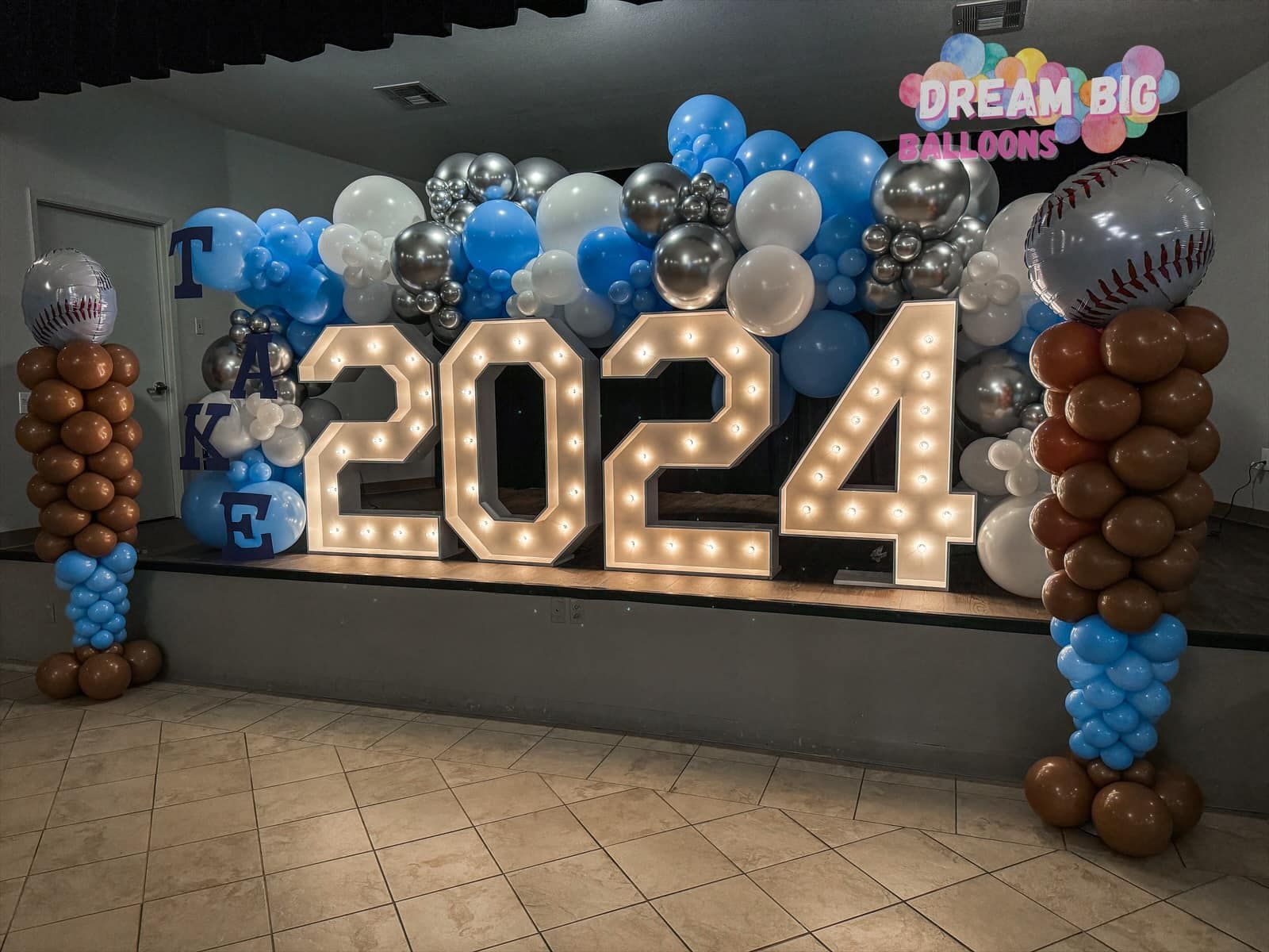 A large sign that says 2024 is surrounded by balloons.