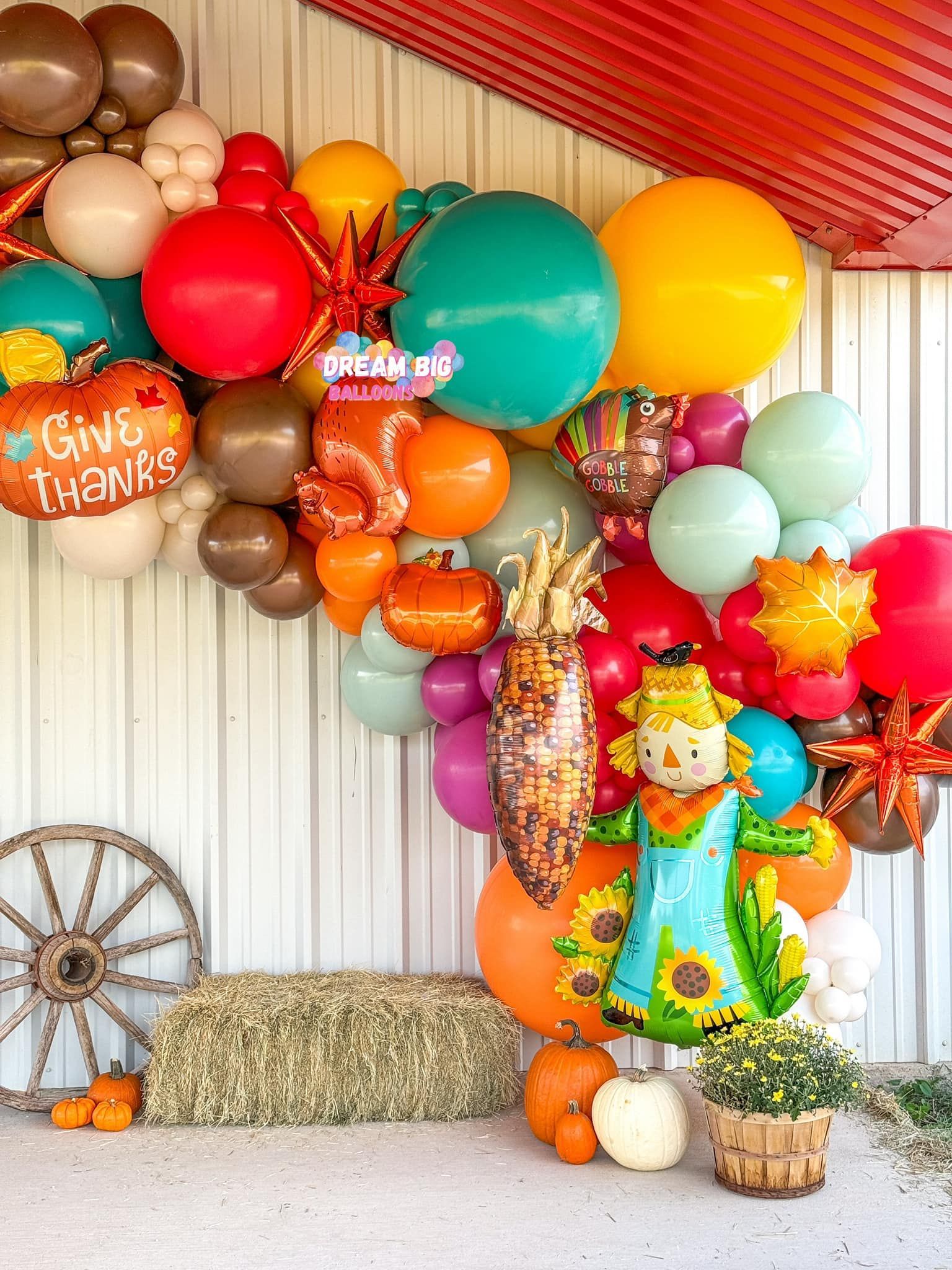 A bunch of balloons are hanging on a wall.