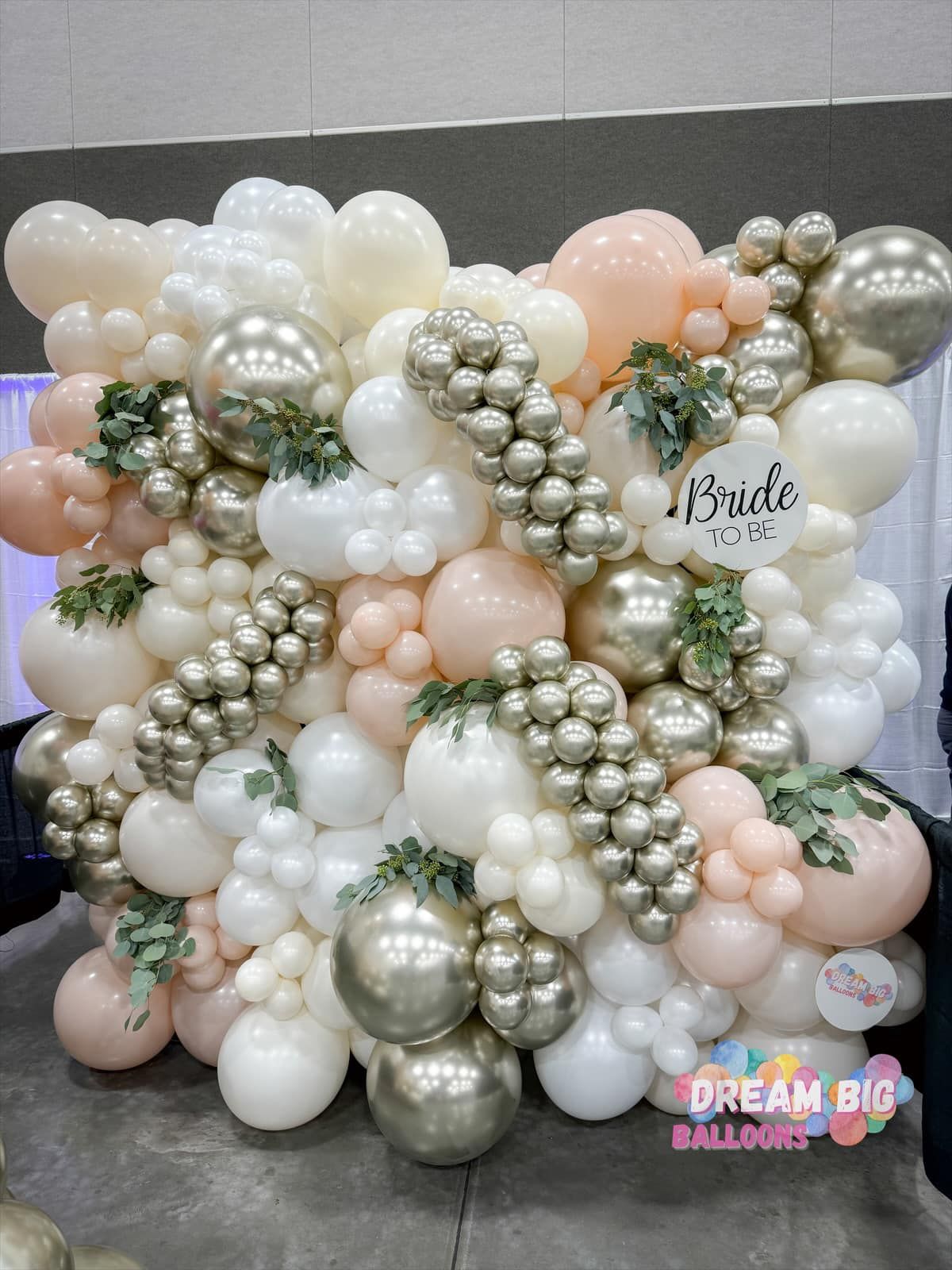 a wall filled with lots of balloons and flowers