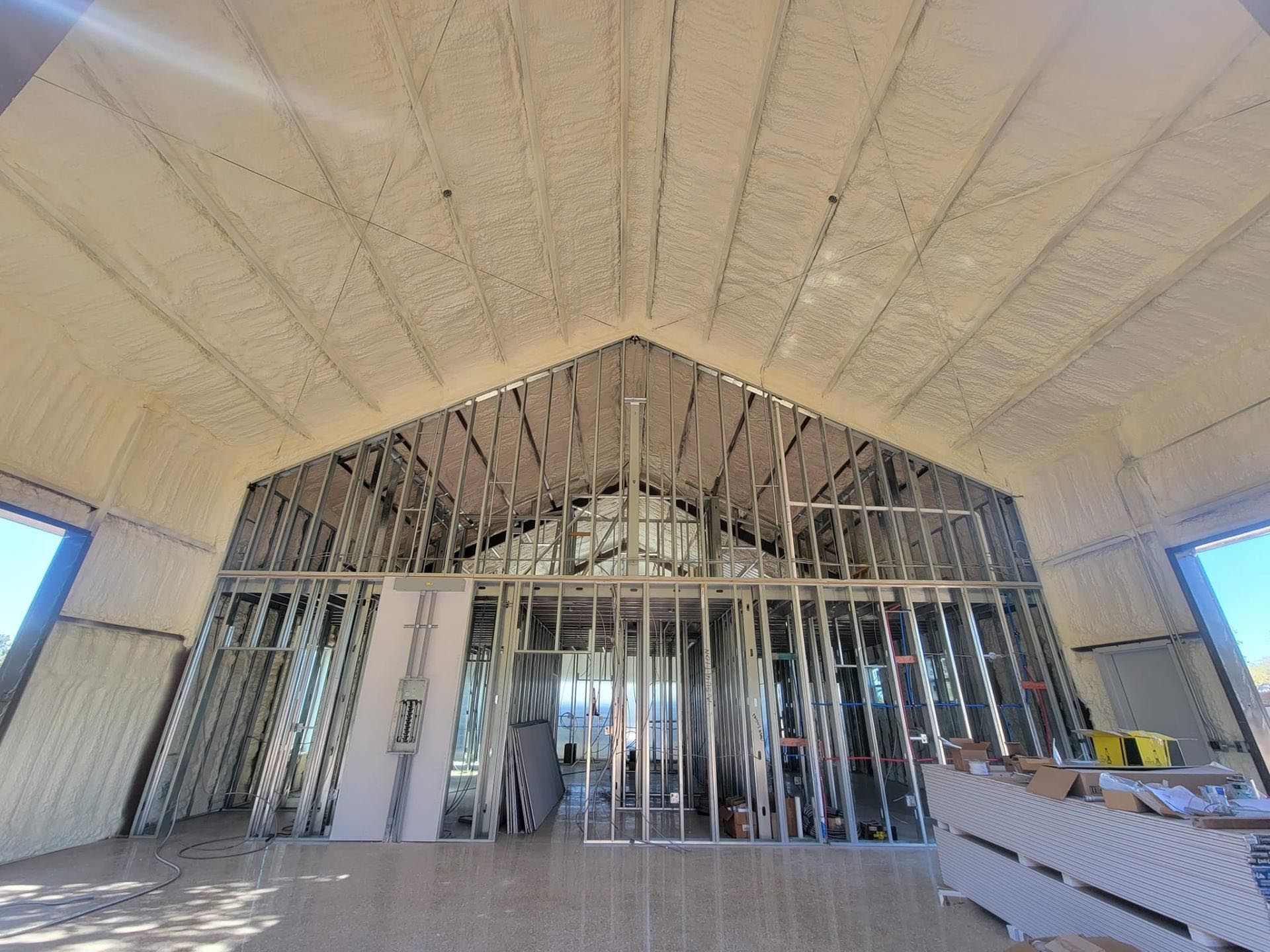 The inside of a building under construction with a vaulted ceiling.