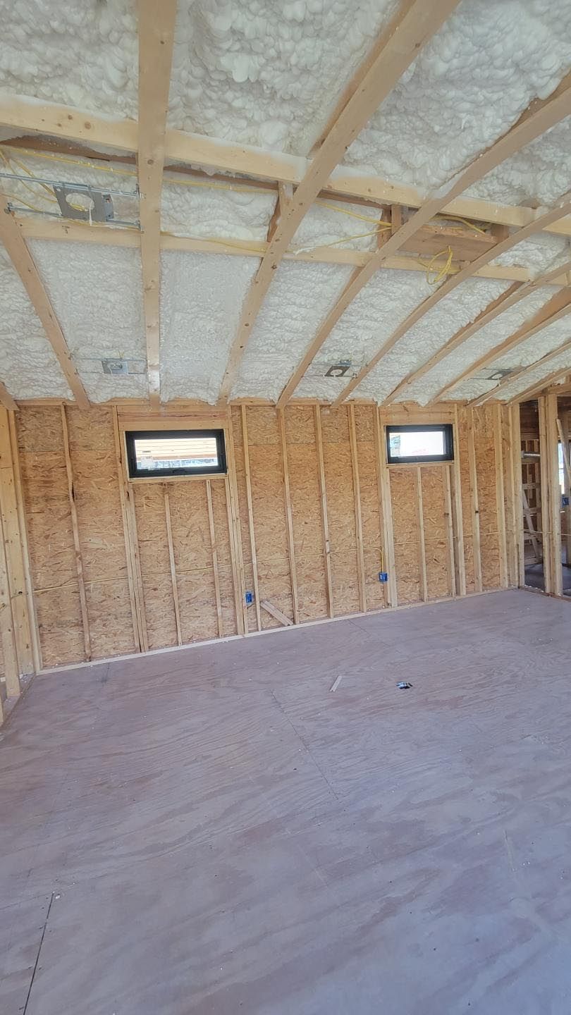 A room with a ceiling that is covered in foam and wooden beams.