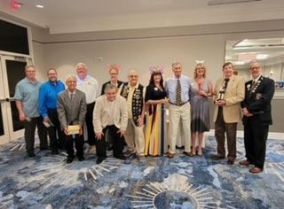 A group of people are posing for a picture in a room.