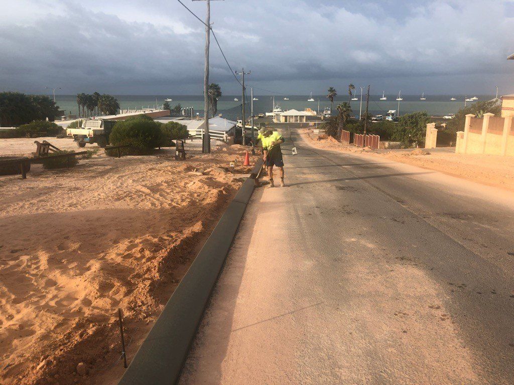 Man checking new kerb | Perth, WA | Kerb Doctor