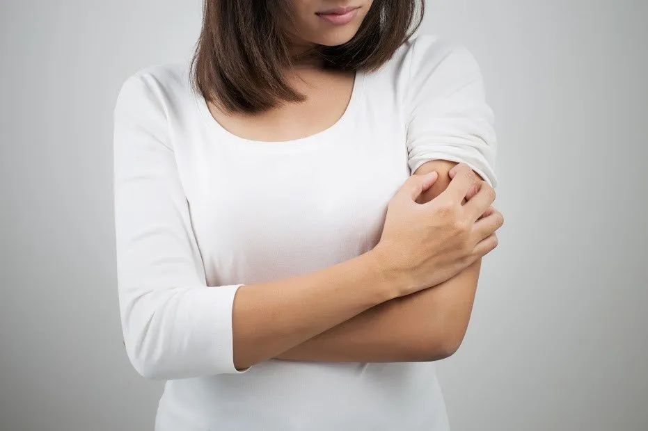 Woman Scratching Her Shoulder — Muncie, IN — American Pest Control