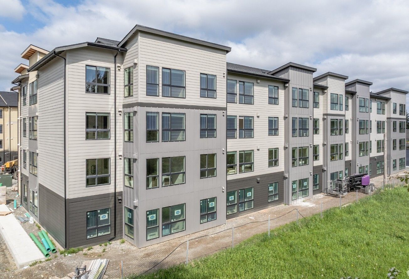 A large apartment building under construction with a lot of windows.