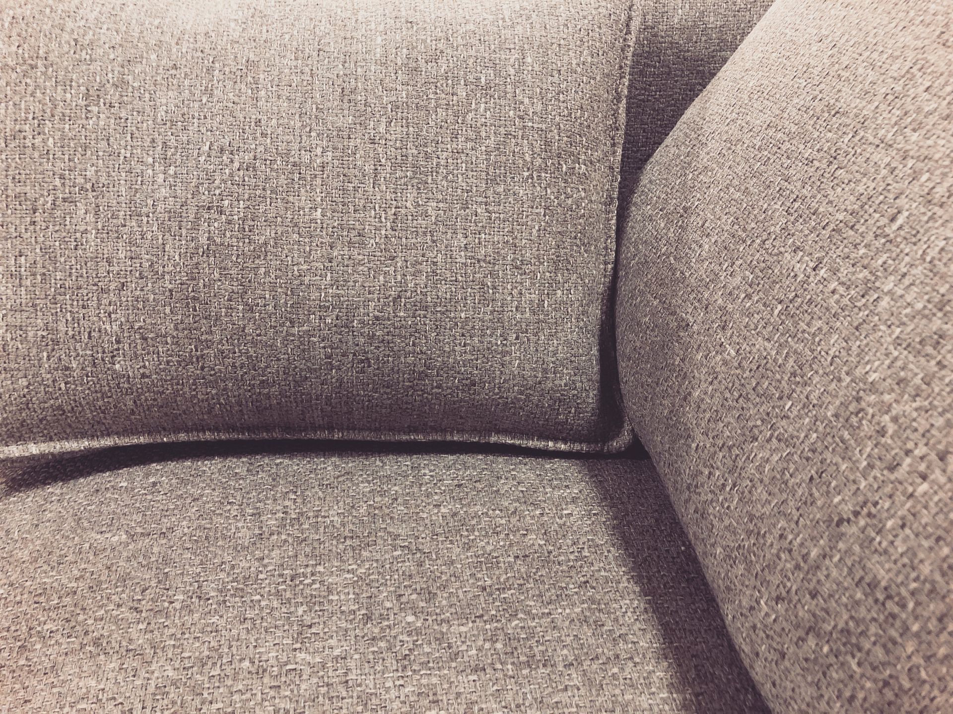 Close-up abstract of grey toned upholstery and cushion