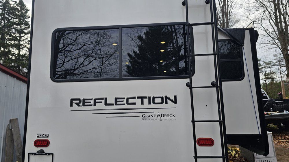 White RV with black ladder, 