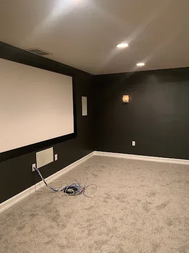 There is a projector screen in the middle of the room.