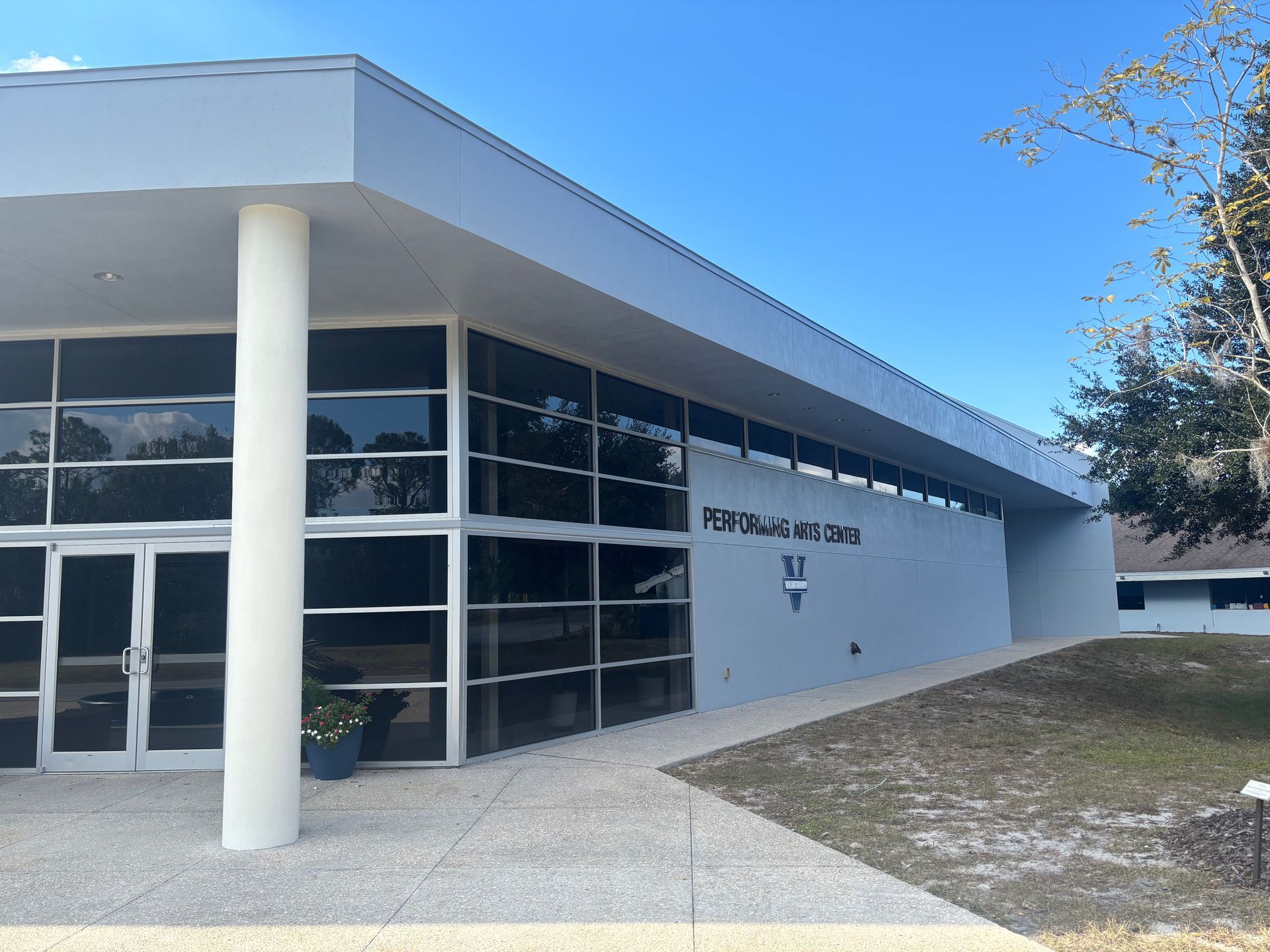 Exterior view of the First Missionary Baptist Church Family Life Center building, light blue walls, glass windows, blue sky.