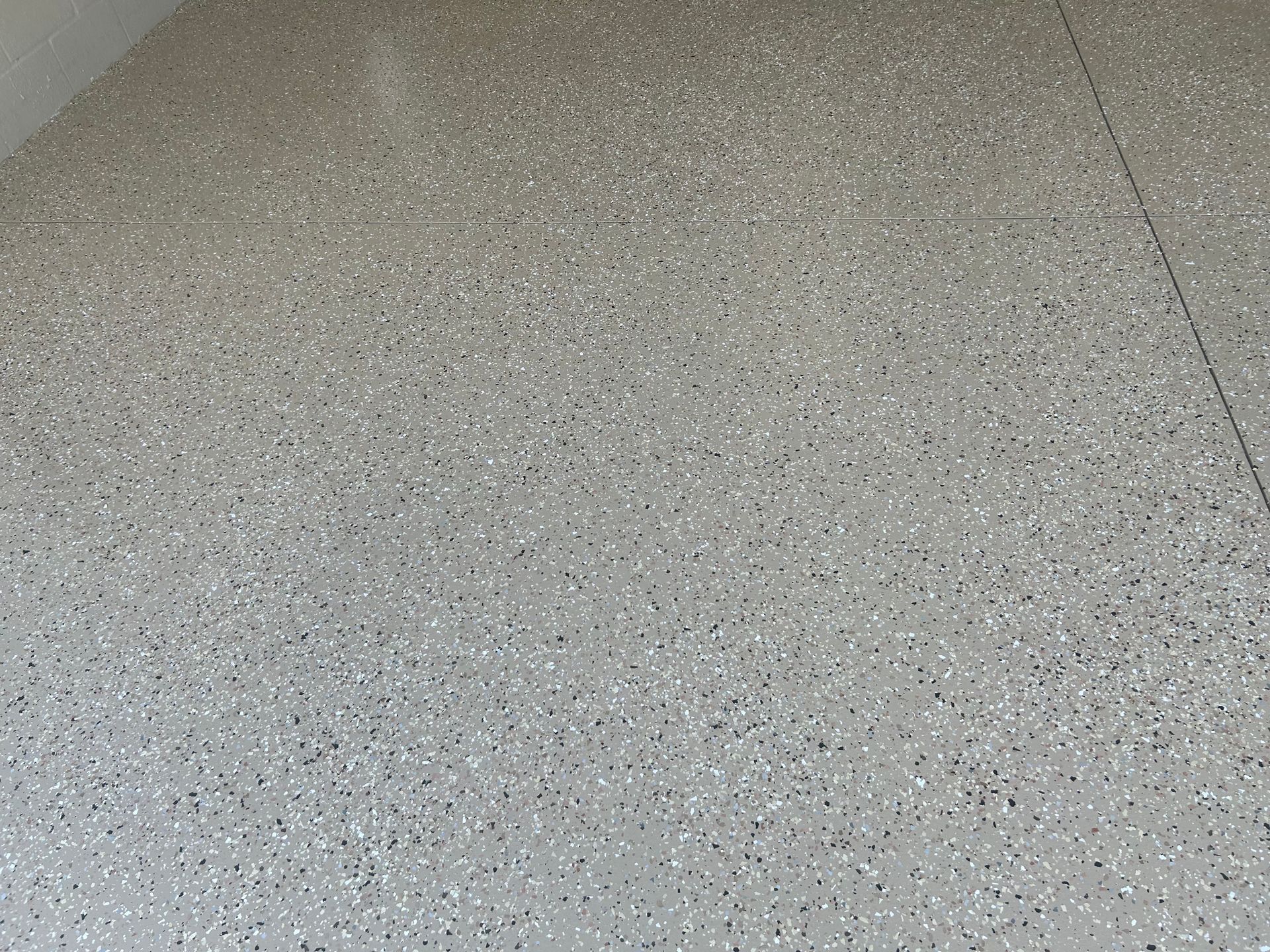 Gray speckled epoxy flooring, seen from above.