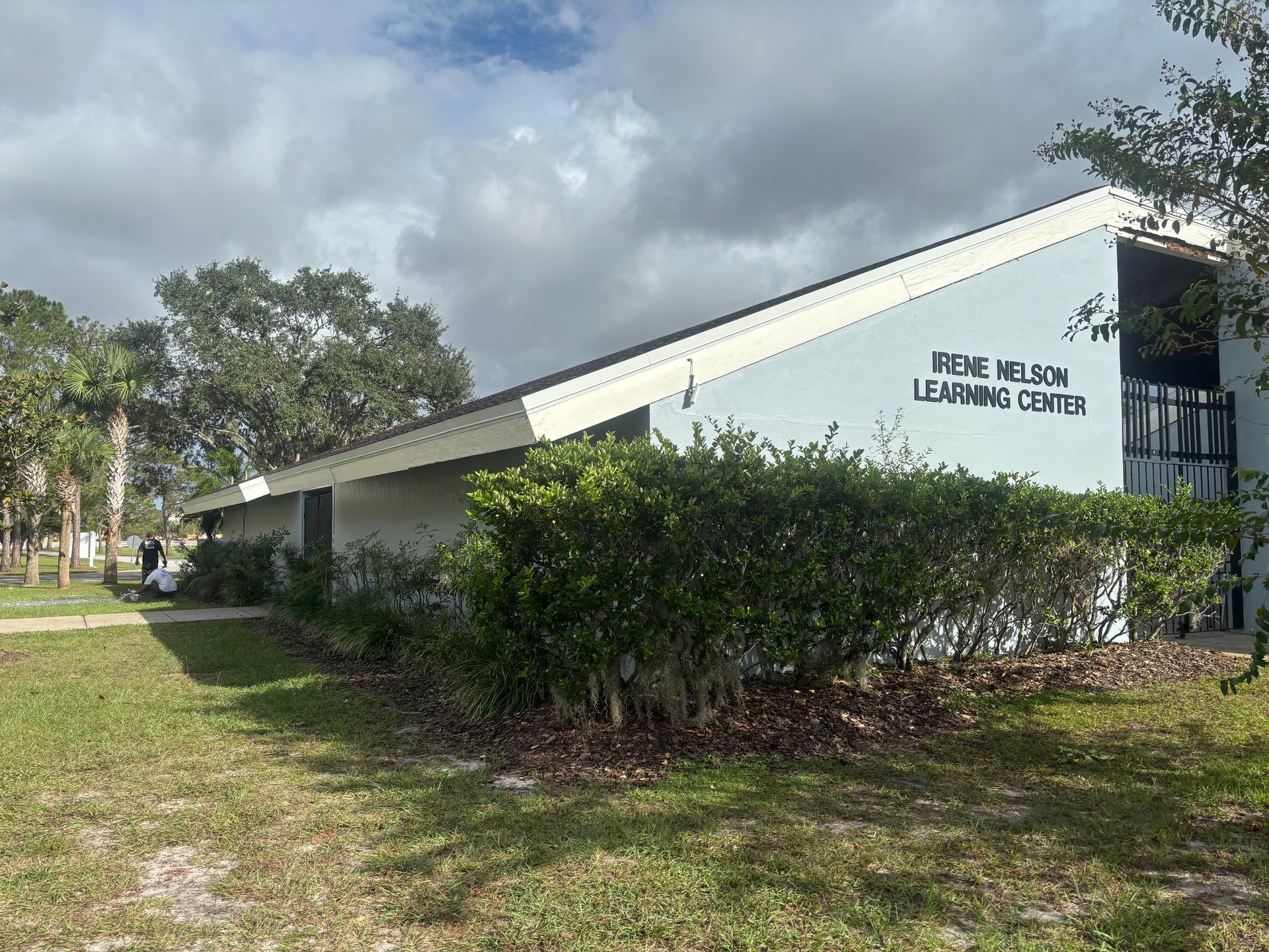 Exterior view of the Keyes Nelson Learning Center, a one-story building with bushes and trees in front.