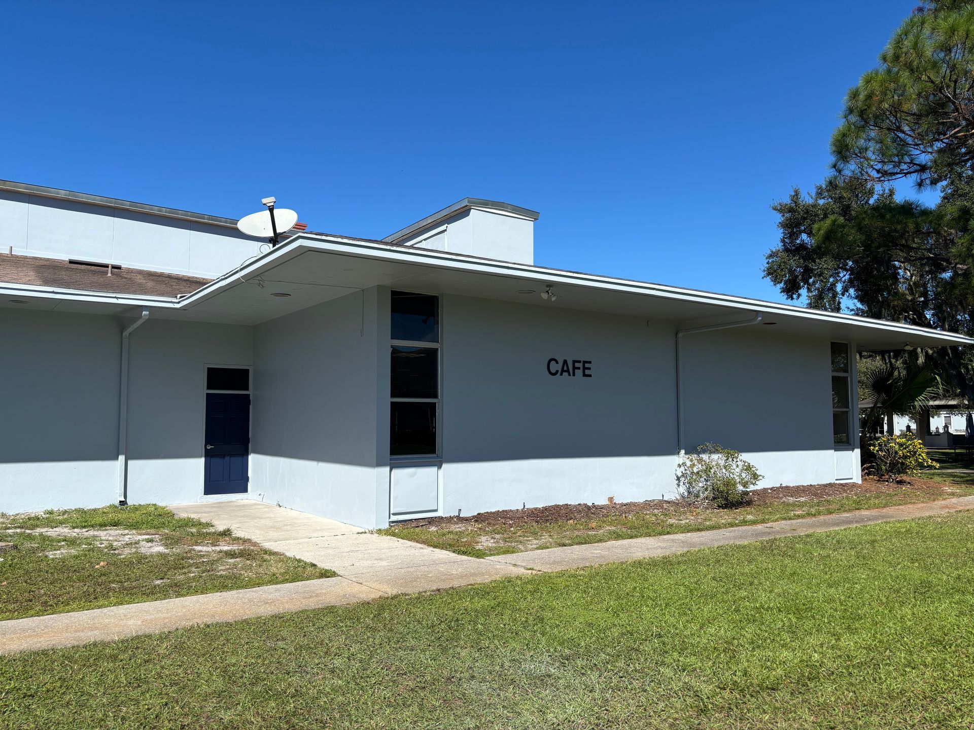 Exterior of a light-gray building labeled 