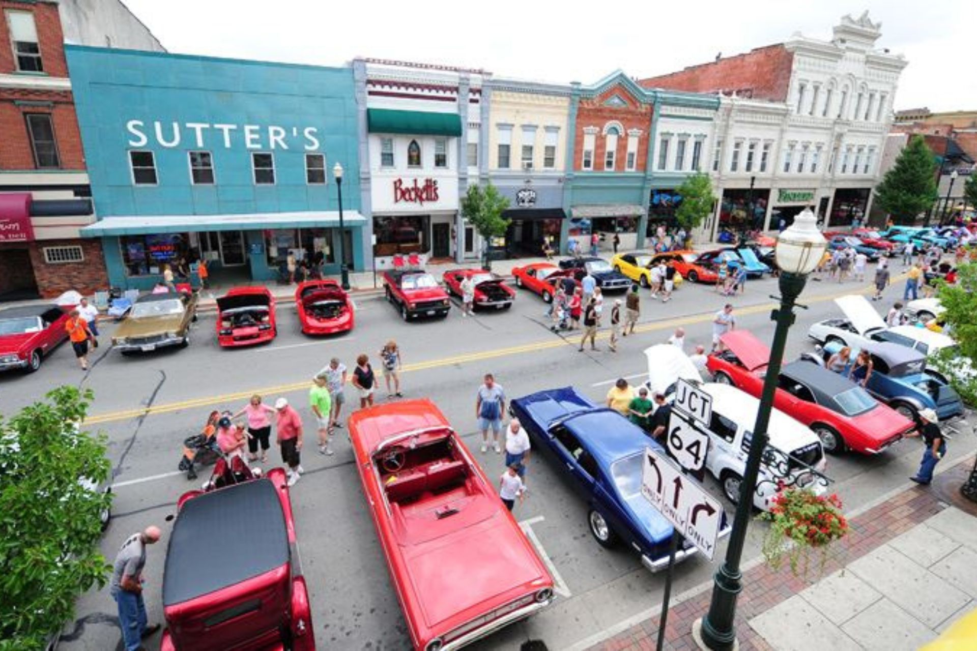 Cars are parked in front of a building that says sutter 's