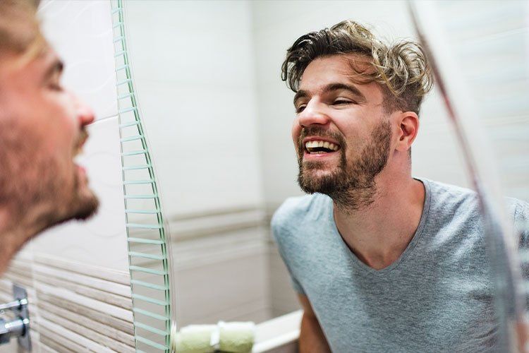 tooth extraction patient looking in the mirror