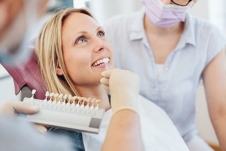 dentist matching veneers color to natural tooth color