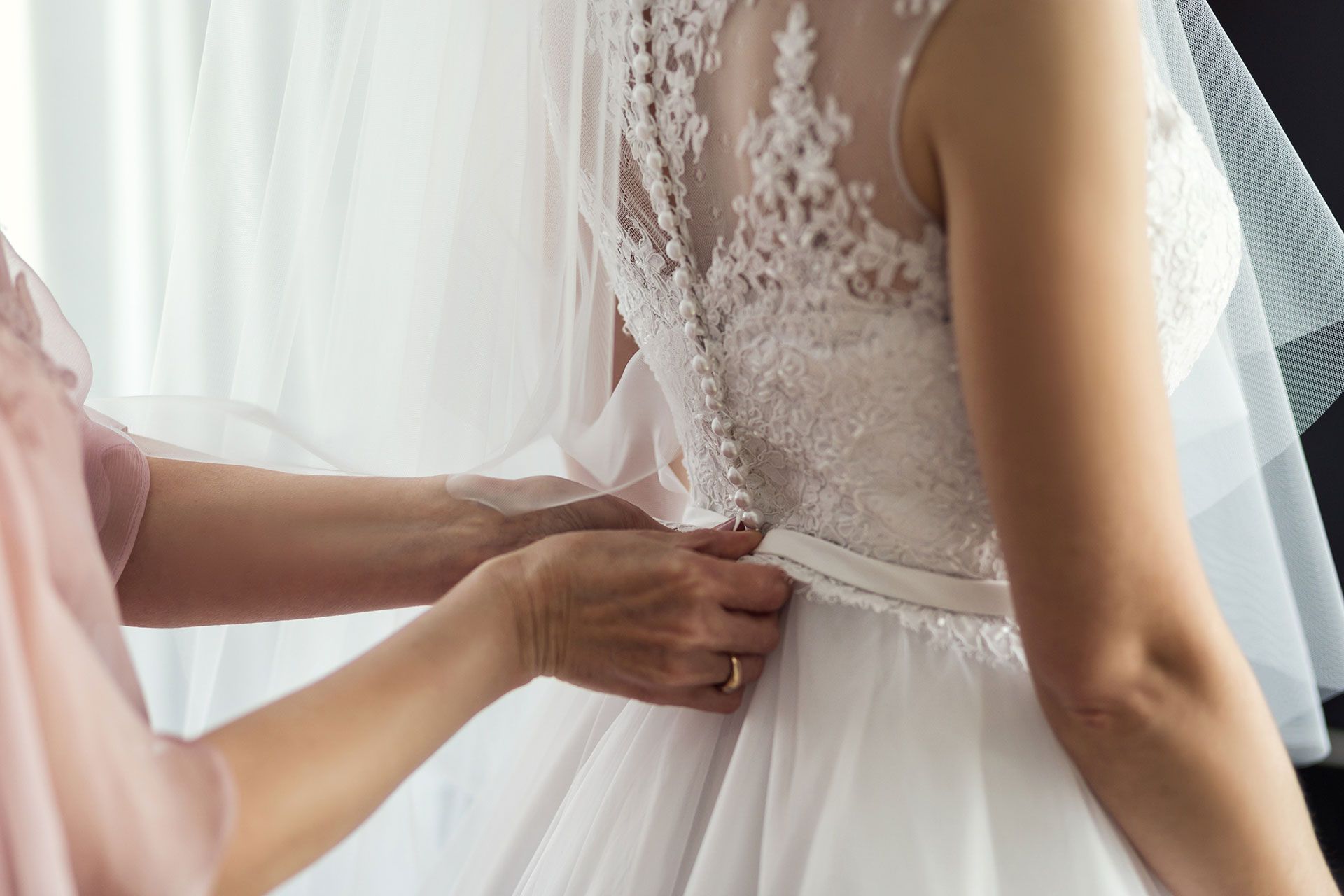 Bride getting wedding dress alterations done