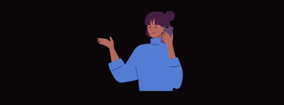 A woman in a blue sweater is talking on a cell phone.