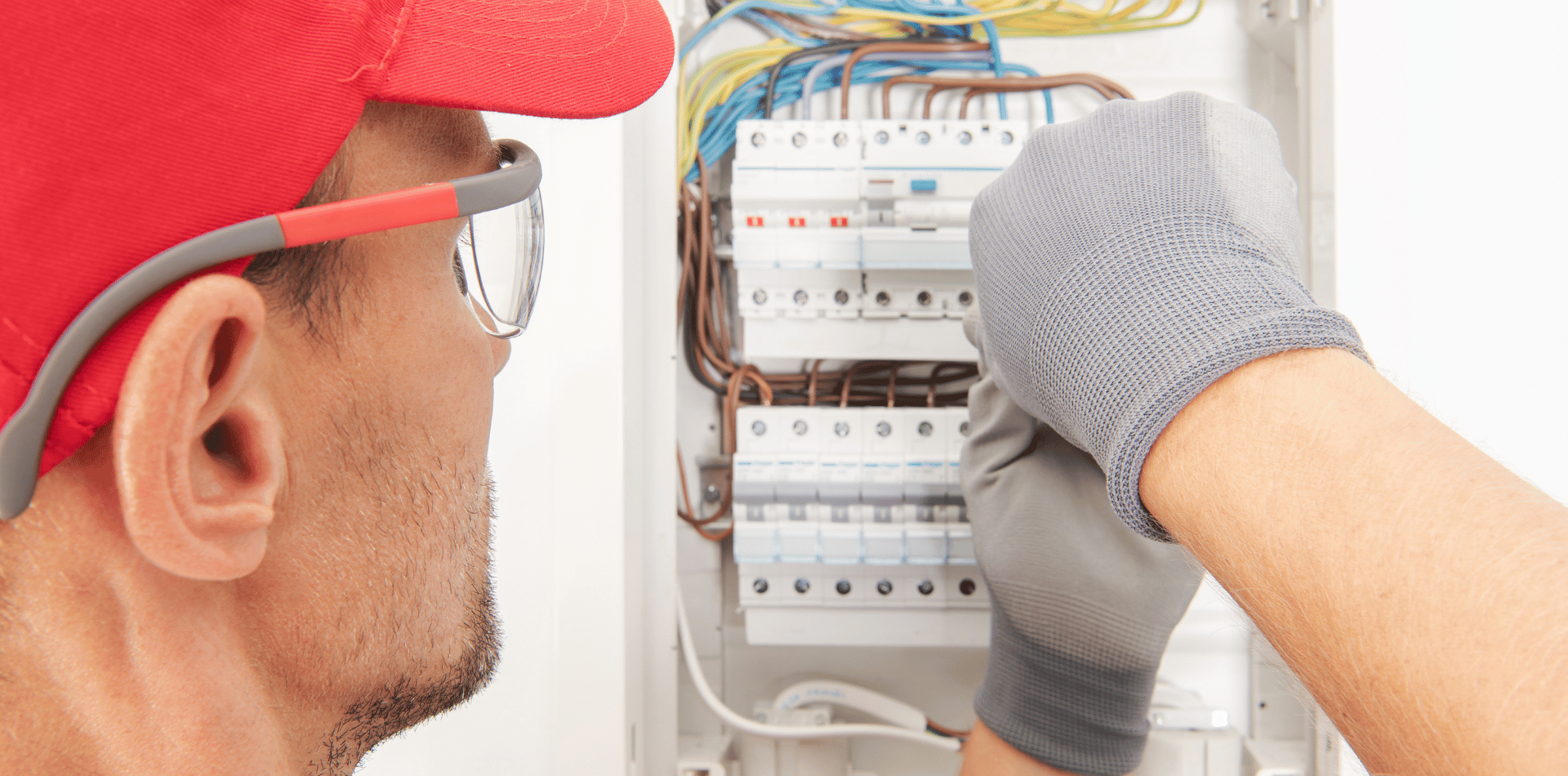 Electrician working on a fuse box.