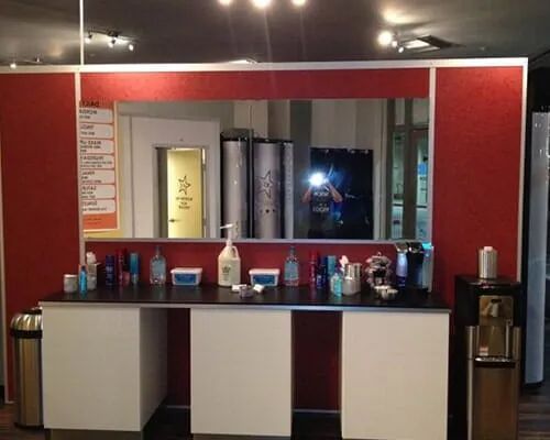 A room with a red wall and a large mirror