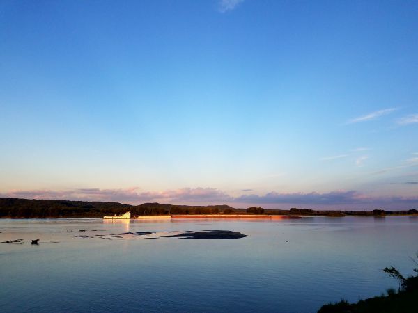 A large body of water with a boat in the distance