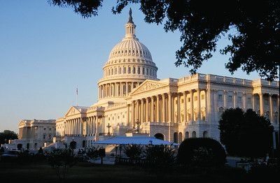 A large white building with a dome on top of it