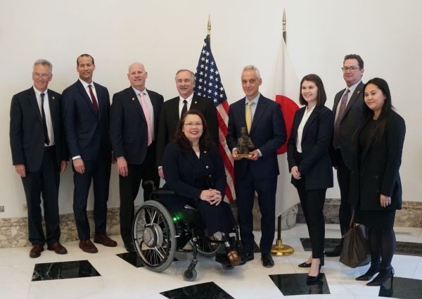 A woman in a wheelchair is standing in front of a group of people