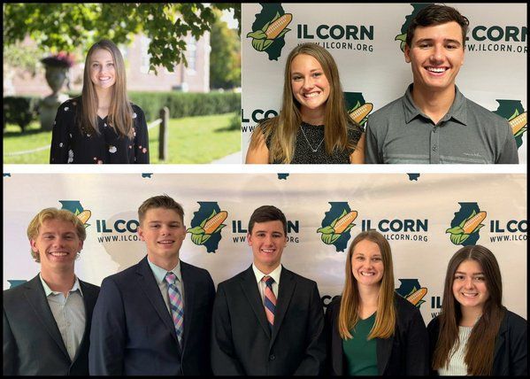 A group of people standing in front of a banner that says ilcorn