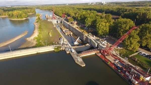 An aerial view of a dam under construction next to a river.