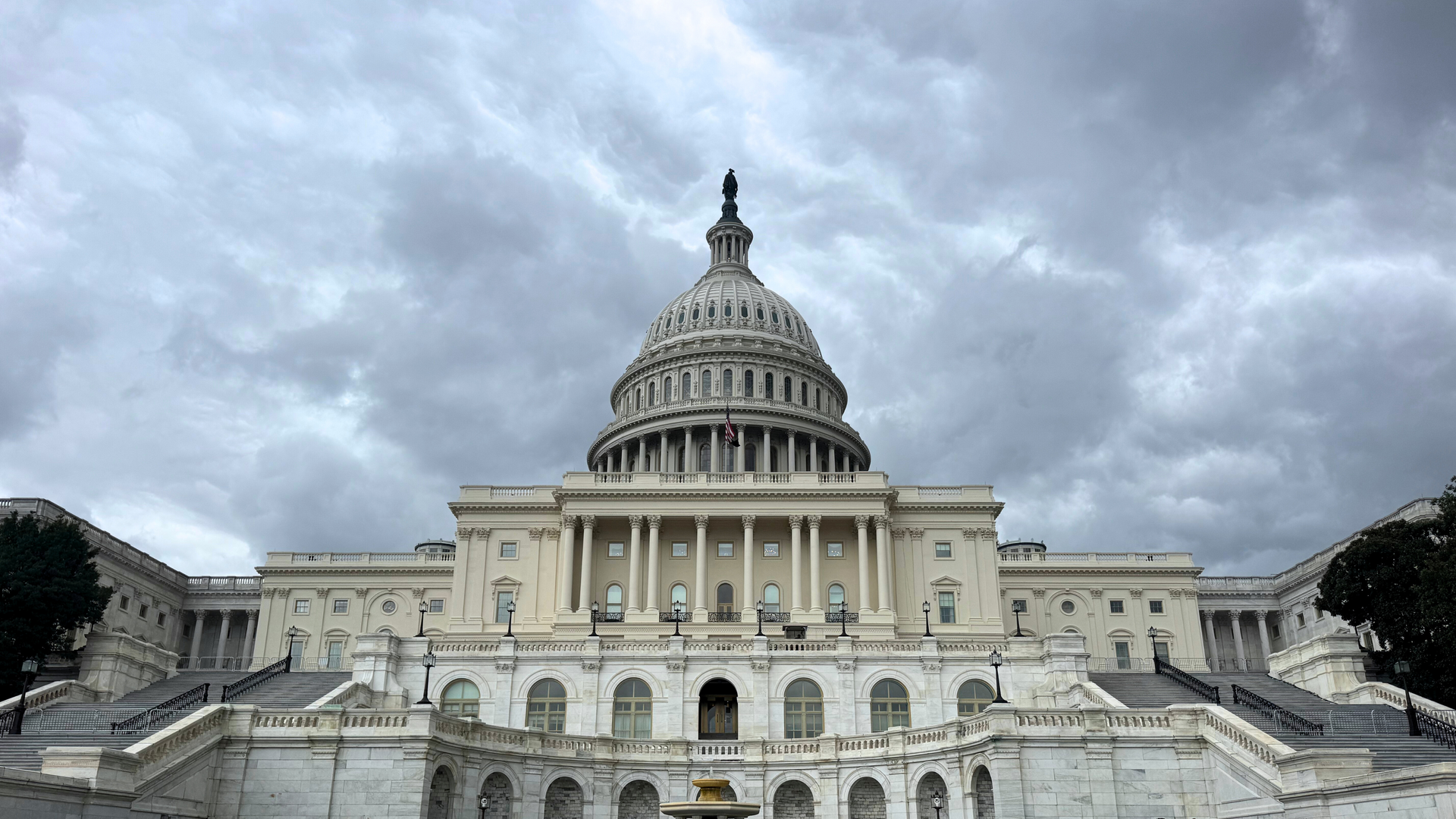 U.S. Capitol Building under a cloudy gray sky.