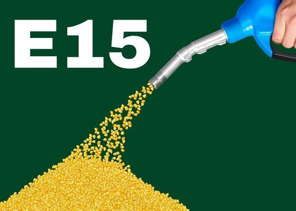 A person is pumping e15 into a pile of corn