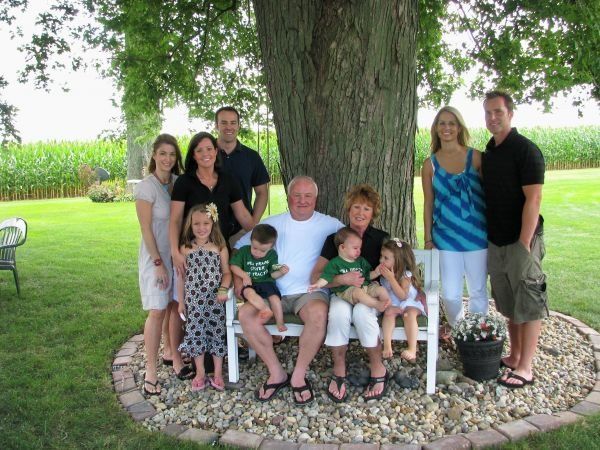 A family posing for a picture under a tree