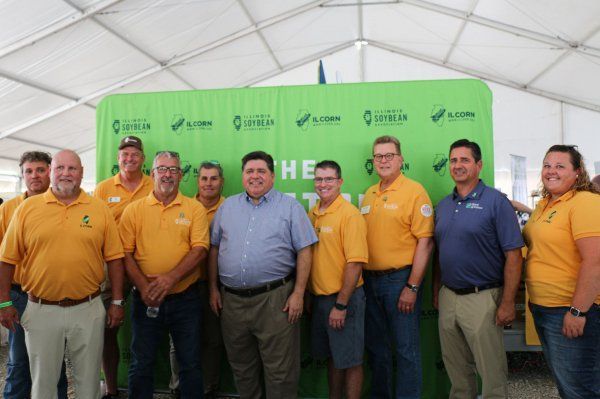 A group of men in yellow shirts are posing for a picture.