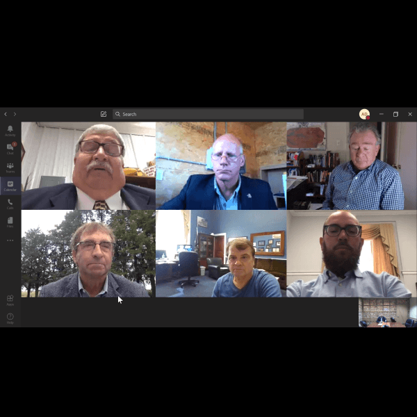 A group of men are having a video call on a computer screen