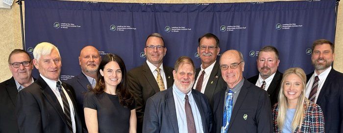 A group of people in suits and ties are posing for a picture.