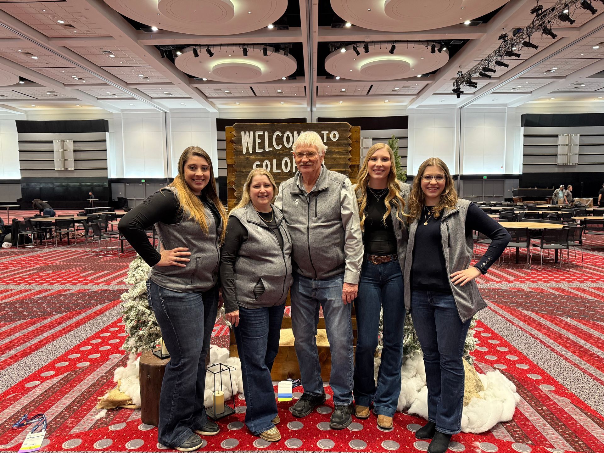 Five people pose in front of a