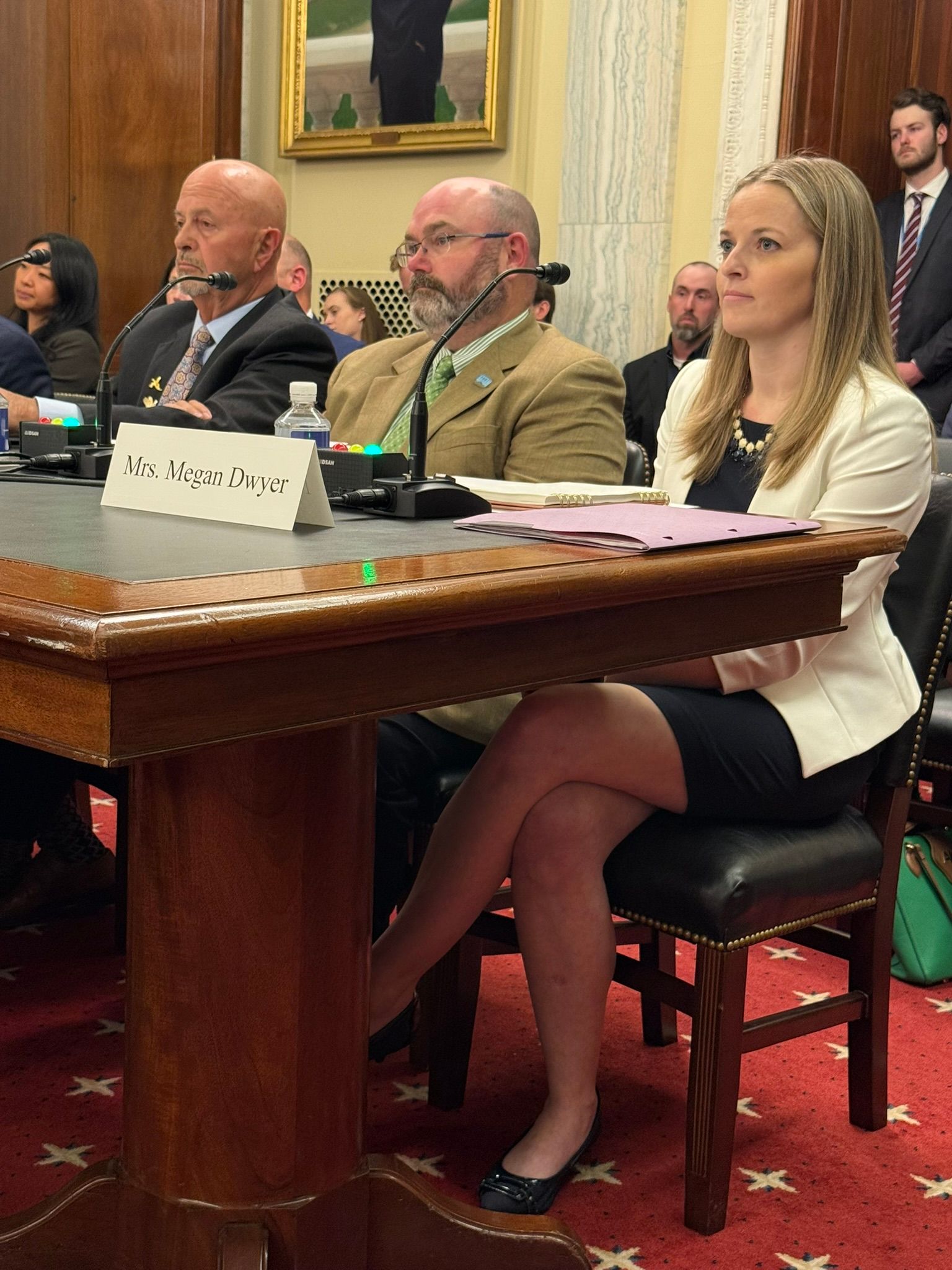 A woman is sitting at a table with her legs crossed