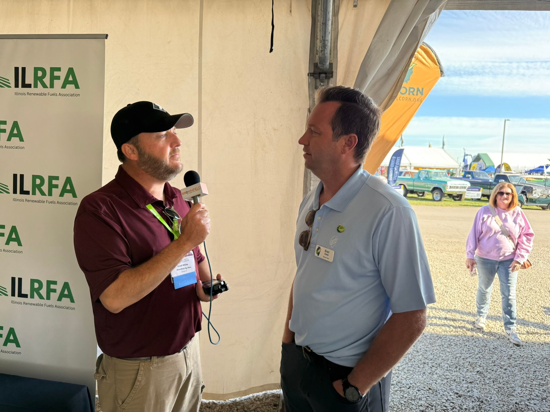 Two men are interviewed at the Illinois Land Improvement Contractors Association event.
