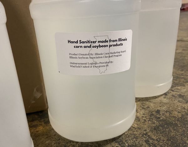 A bottle of hand sanitizer made from corn and soybean products is sitting on a table.