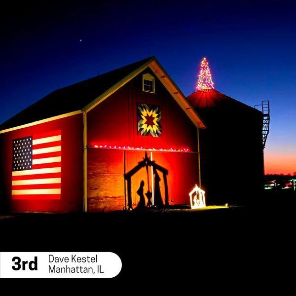 A red barn with a nativity scene in front of it and the number 3rd on the bottom
