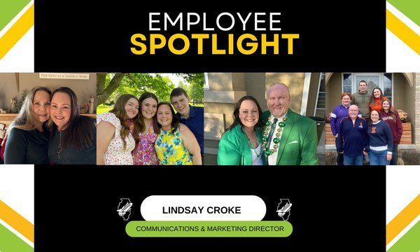 A group of people are posing for a picture in front of a sign that says employee spotlight.