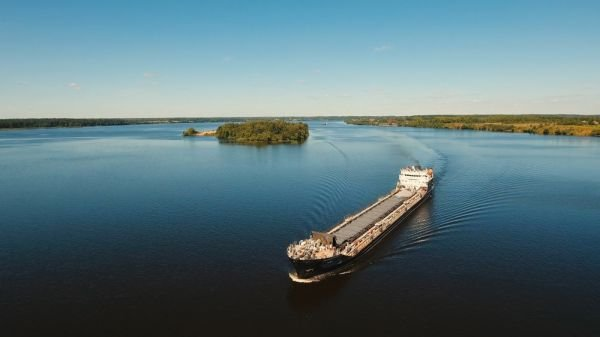 An aerial view of a large ship floating on top of a large body of water.