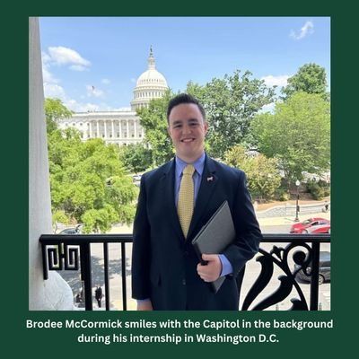 Brodee mccormick smiles with the capitol in the background during his internship in washington d.c.