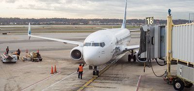 A large passenger jet is parked on the tarmac at an airport.