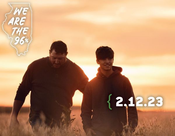 Two men walking in a field with the date 2.12.23
