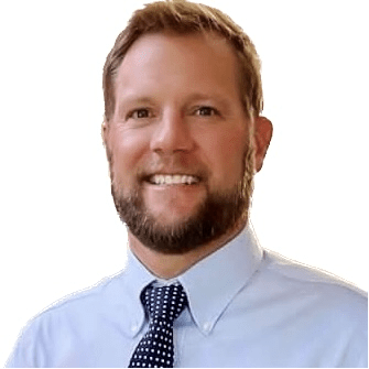 A man with a beard and tie is smiling for the camera.