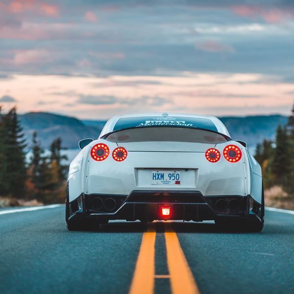 A white sports car with a license plate that says hkm 950