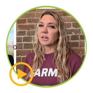 A woman wearing a purple shirt that says farm