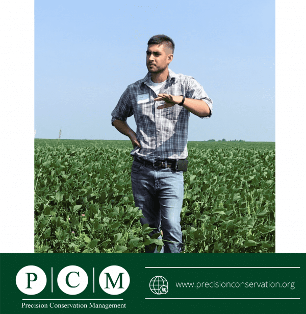 A man standing in a field with precision conservation management written on the bottom