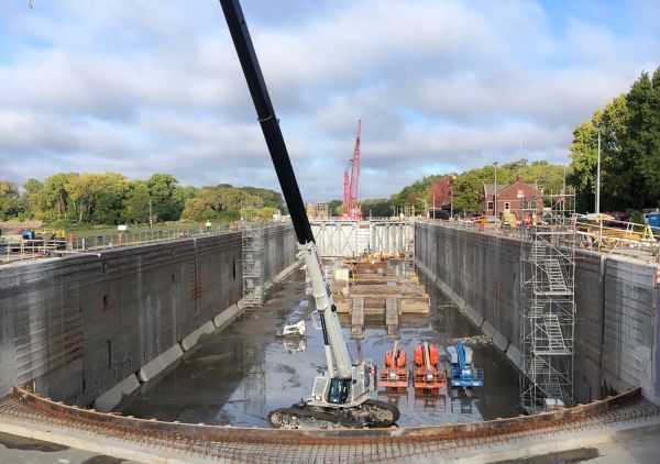 A large body of water with a crane in the middle of it.
