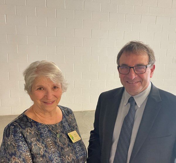 A man and a woman are posing for a picture together